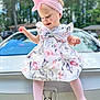 Ariyah joined the competition — help win amazing prizes! toddler, child, smiling, dress, headband, pink, car, honda, license_plate, outdoor, trees, daylight, happy, cute, playful, vehicle, person, portrait, sitting, clothing