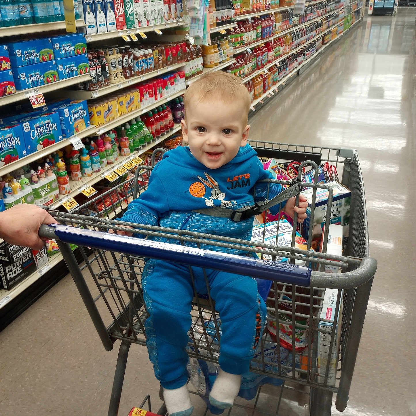 Rylan joined the competition — help win amazing prizes! aisle, beverages, blue_clothing, casual_clothing, child, face, floor, groceries, hand, indoor, juice, person, retail, shelf, shopping, shopping_cart, smiling, snacks, supermarket, toddler
