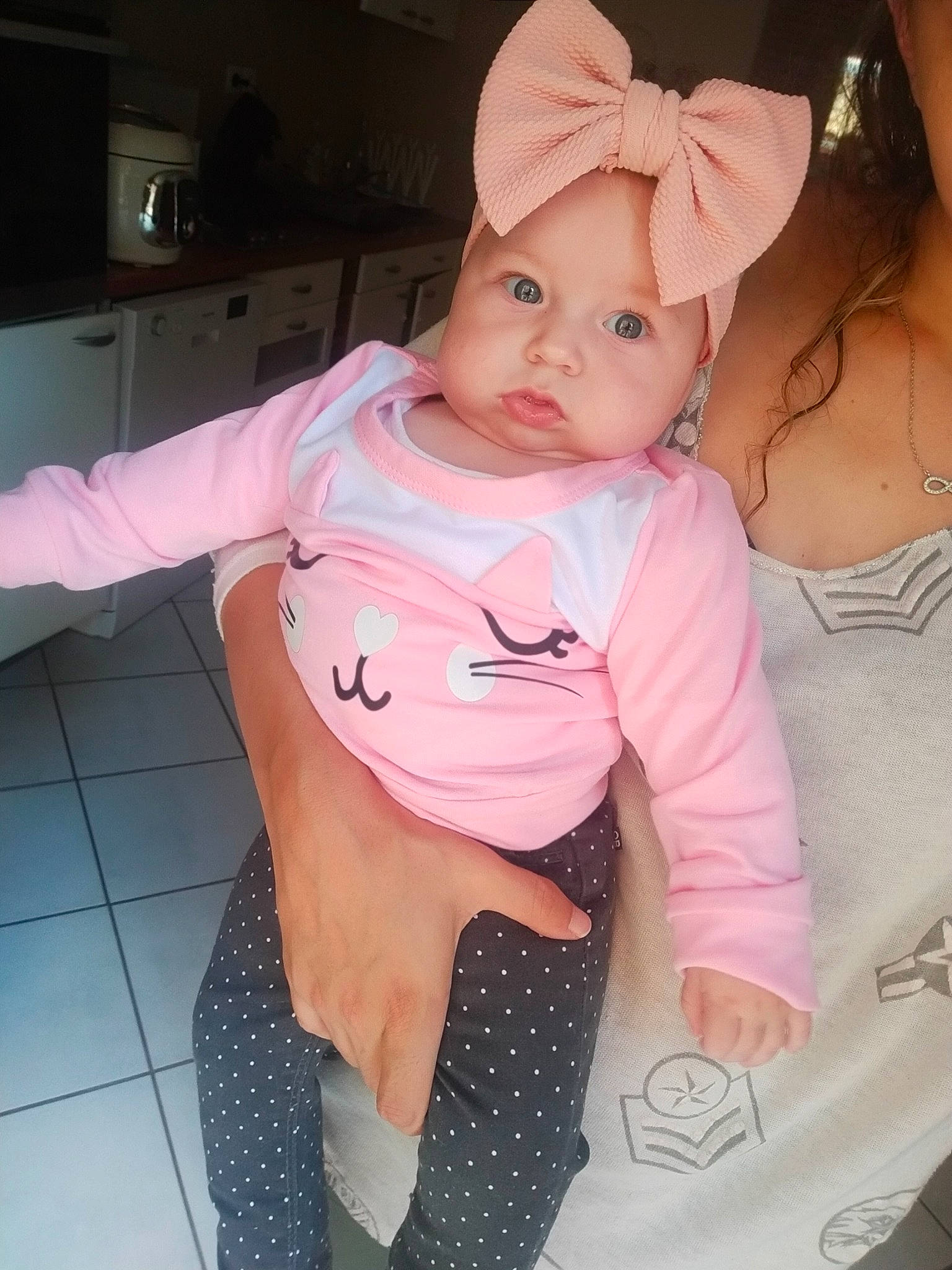 Shanna participe au concours pour gagner de l'argent avec cette photo : arm, baby, baby_toddler_clothing, cap, cheek, comfort, gesture, happy, headgear, headwear, human_body, joint, lip, mouth, neck, person, pink, shoulder, skin, sleeve