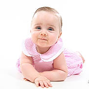 Tessa participe au concours pour gagner de l'argent avec cette photo : baby, infant, child, pink_dress, striped_clothing, blue_eyes, lying_down, studio_photo, white_background, cute, smiling, portrait, person, skin, hand, face, head, young_child, photography, baby_girl