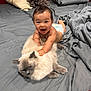 Ethan participe au concours pour gagner de l'argent avec cette photo : animal, baby, bed, cat, child, cute, diaper, domestic_animal, feline, fluffy_cat, fur, gray_bedspread, happy_baby, indoor, infant, person, pet, playful, resting, smiling