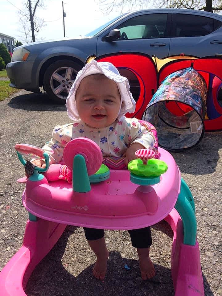Harper is registered to the contest to win money with this photo: car, child, fun, headwear, person, pink, play, sitting, smile, toddler, vehicle