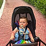 Aaron participe au concours pour gagner de l'argent avec cette photo : toddler, stroller, pacifier, child, toy, pop_it, outdoor, pathway, greenery, girl, running, dress, summer, sunlight, cute, baby, playful, nature, casual, happy