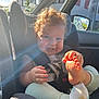 Aaron a rejoint le concours — aidez-le/la à gagner de superbes lots ! baby, child, car_seat, curly_hair, smile, foot, hand, sunlight, window, car_interior, seatbelt, clothing, sock, happy, cute, infant, playful, daylight, vehicle, portrait