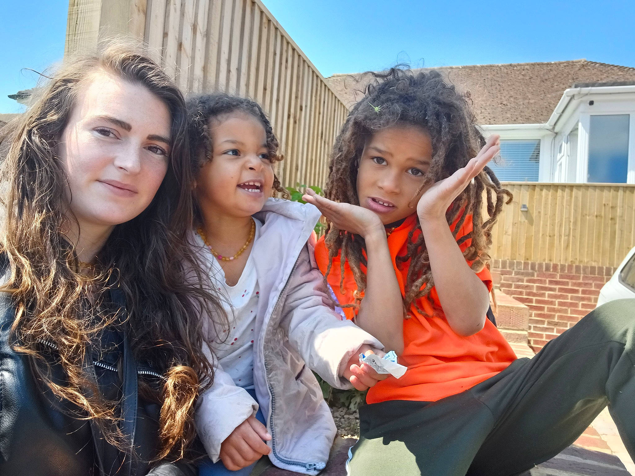 Roman Garry is registered to the contest to win money with this photo: black_hair, child, conversation, event, eye, fun, gesture, grass, happy, joy, leisure, person, recreation, sitting, sky, smile, team, thigh, tourism, travel