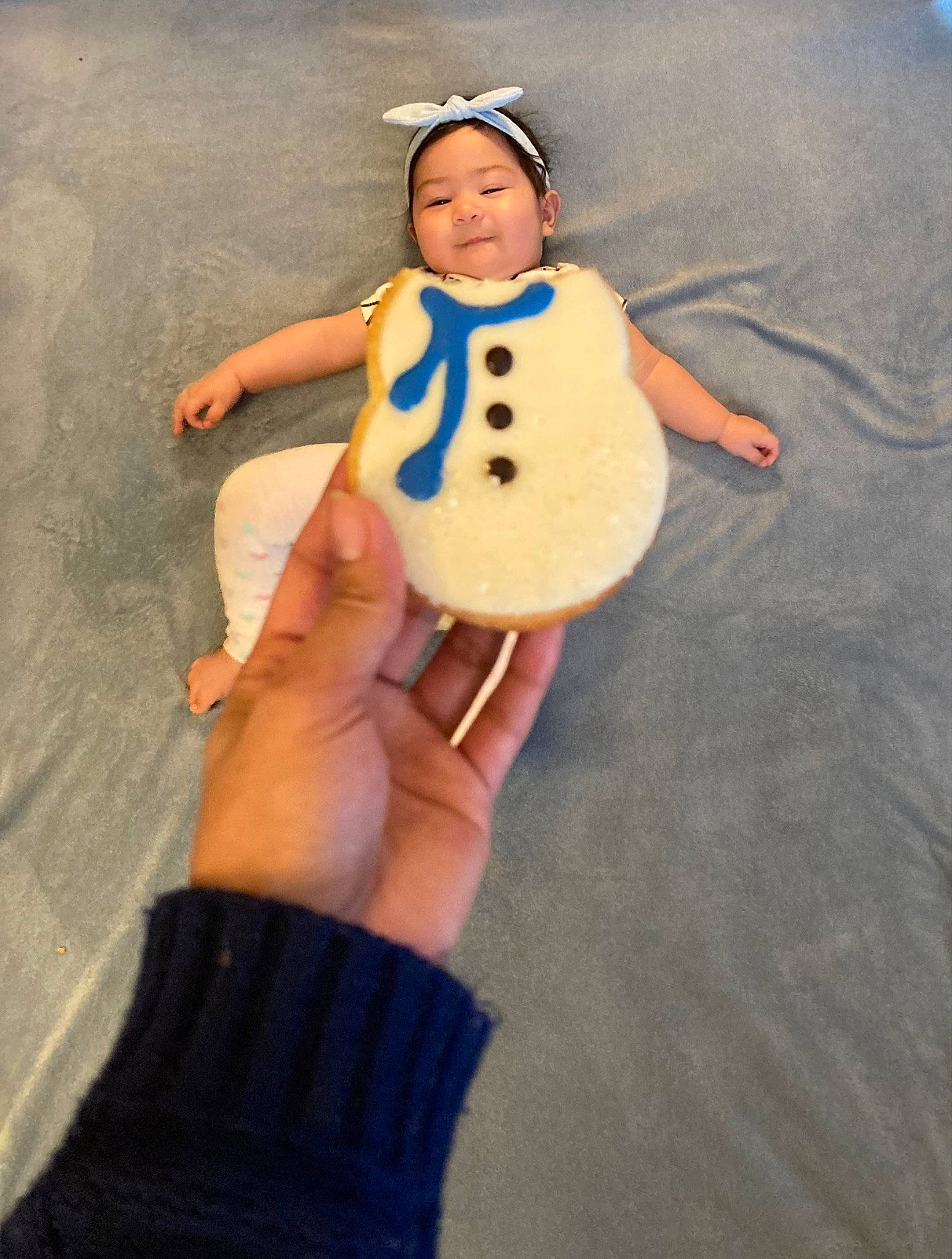 Clarissa is registered to the contest to win money with this photo: baby, baby_toddler_clothing, ball, child, eye, finger, football, fun, gesture, happy, head, insect, nail, person, personal_protective_equipment, sand, sleeve, smile, t_shirt, thumb