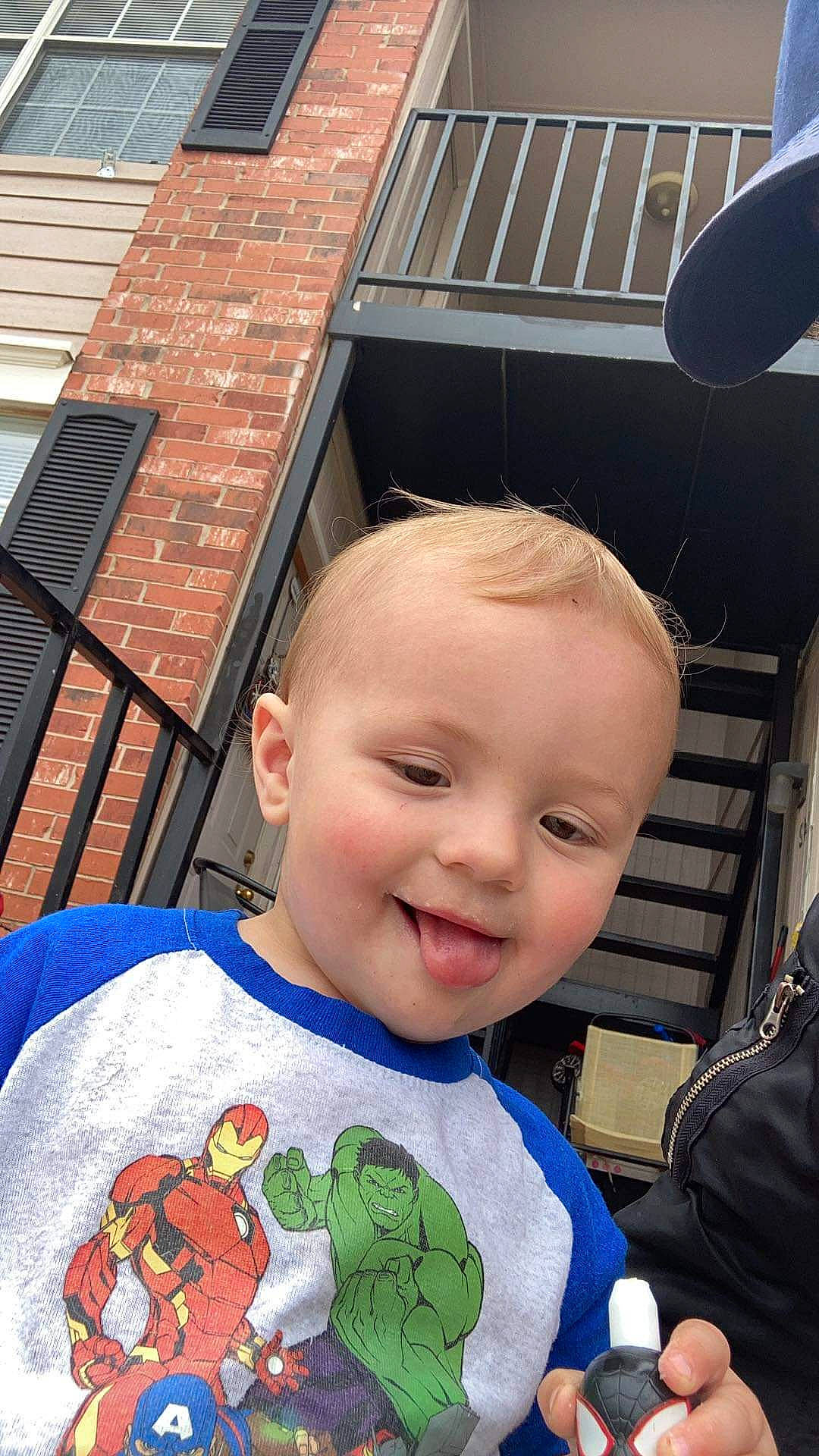 Karson is registered to the contest to win money with this photo: baby, baby_toddler_clothing, blue, child, cool, fun, happy, joy, leisure, mouth, pattern, person, sleeve, smile, snapshot, standing, t_shirt, toddler, travel, vacation