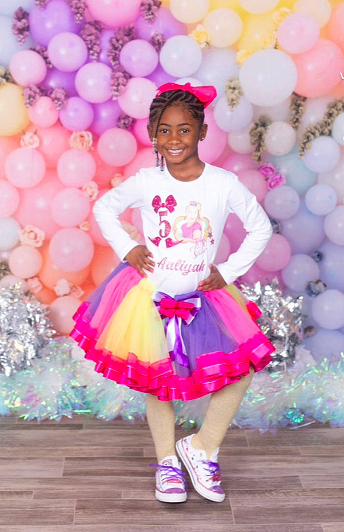Aaliyah is registered to the contest to win money with this photo: baby_toddler_clothing, balloon, child, day_dress, event, fashion_design, formal_wear, fun, happy, joy, leisure, magenta, party, party_supply, pattern, person, pink, purple, recreation, ruffle