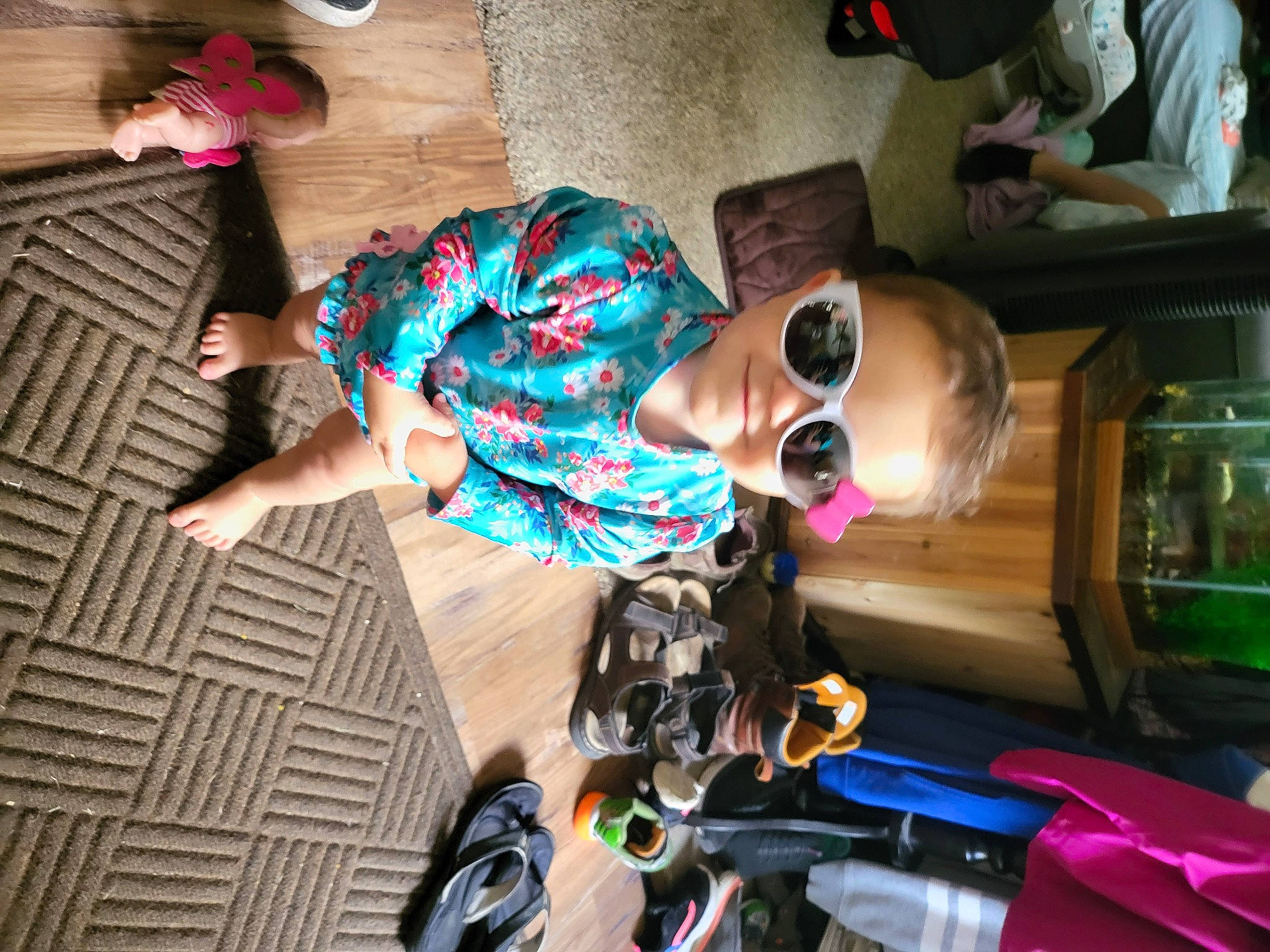 Hazel is registered to the contest to win money with this photo: child, cool, eyewear, flooring, fun, goggles, helmet, human_leg, leisure, person, personal_protective_equipment, pink, recreation, room, sandal, shoe, smile, sunglasses, thigh, toddler