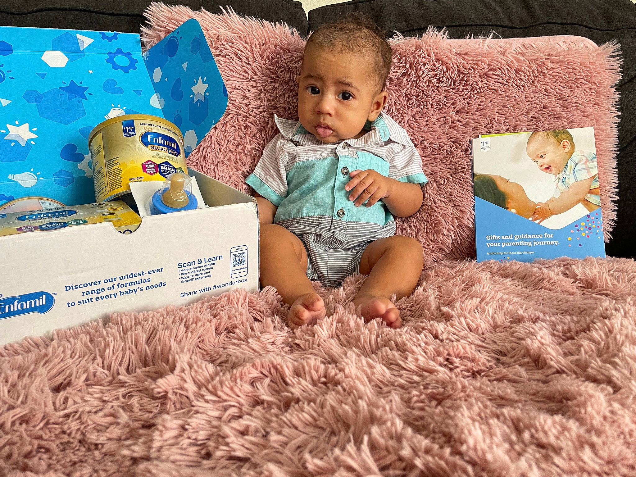 Bella is registered to the contest to win money with this photo: aqua, azure, baby, baby_toddler_clothing, blue, chair, child, comfort, couch, happy, linens, pattern, person, photograph, product, room, sitting, surprise, t_shirt, textile