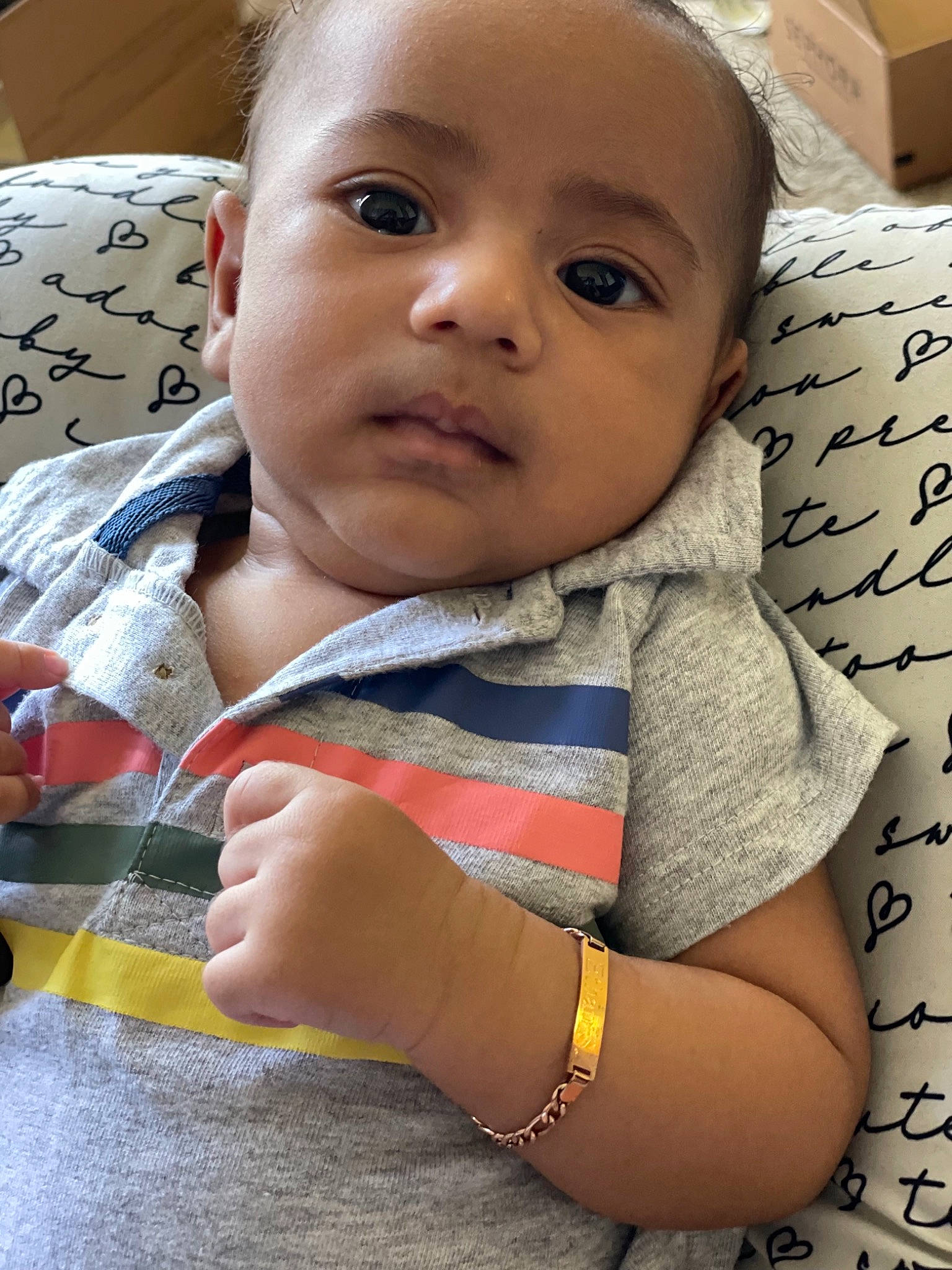 Ethan is registered to the contest to win money with this photo: baby, baby_products, baby_toddler_clothing, cheek, child, comfort, eyebrow, eyelash, finger, happy, iris, lip, mouth, nail, nose, pattern, person, sitting, skin, sleeve