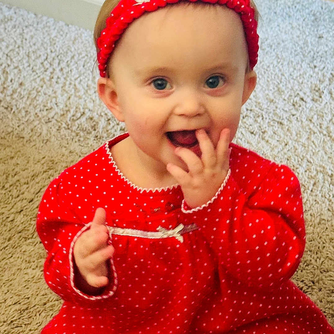 Kinsleigh is registered to the contest to win money with this photo: accessories, baby, bodypart, clothing, costume, cutlery, face, food, happy, hat, head, mouth, pajamas, person, photography, portrait, sitting, spoon, sweets, teeth