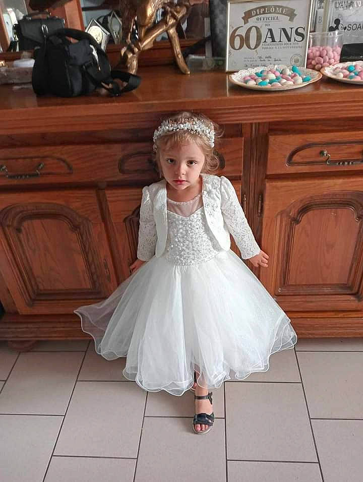 Ilionna a rejoint le concours — aidez-le/la à gagner de superbes lots ! bridal_accessory, bridal_clothing, bridal_party_dress, cabinetry, dress, embellishment, event, fashion_design, floor, flooring, formal_wear, gown, happy, headpiece, person, pink, sleeve, suit, toddler, wedding_ceremony_supply