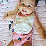 baby, child, infant, smiling, tongue_out, striped_clothing, bib, quilt, pink, animal_pattern, lying_down, cute, happy, cheerful, indoor, person, skin, head, face, arm