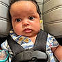 baby, infant, car_seat, seatbelt, pacifier, striped_shirt, baseball_patch, closeup, child, cute, face, expression, indoors, safety, clothing, head, person, newborn, young_child, portrait