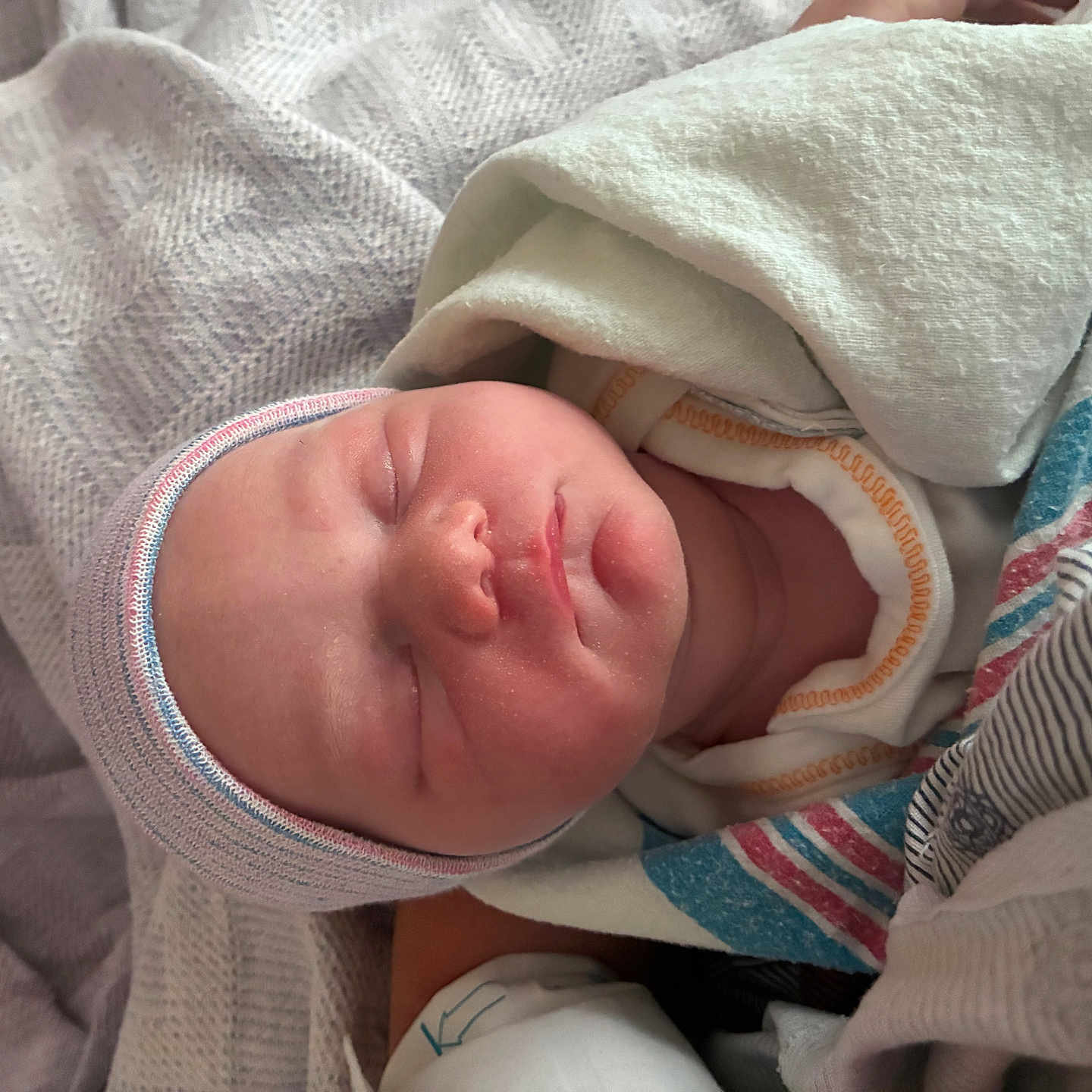 Kyla joined the competition — help win amazing prizes! newborn, baby, sleeping, infant, portrait, face, closed_eyes, blanket, swaddled, hospital, cap, hat, cozy, peaceful, indoors, close_up, textile, pink_skin, resting, family