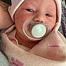 Kyla joined the competition — help win amazing prizes! newborn, baby, infant, child, face, pacifier, blanket, swaddled, hat, pink, butterfly, portrait, close_up, indoors, person, eyes, nose, mouth, tattoo, caregiver