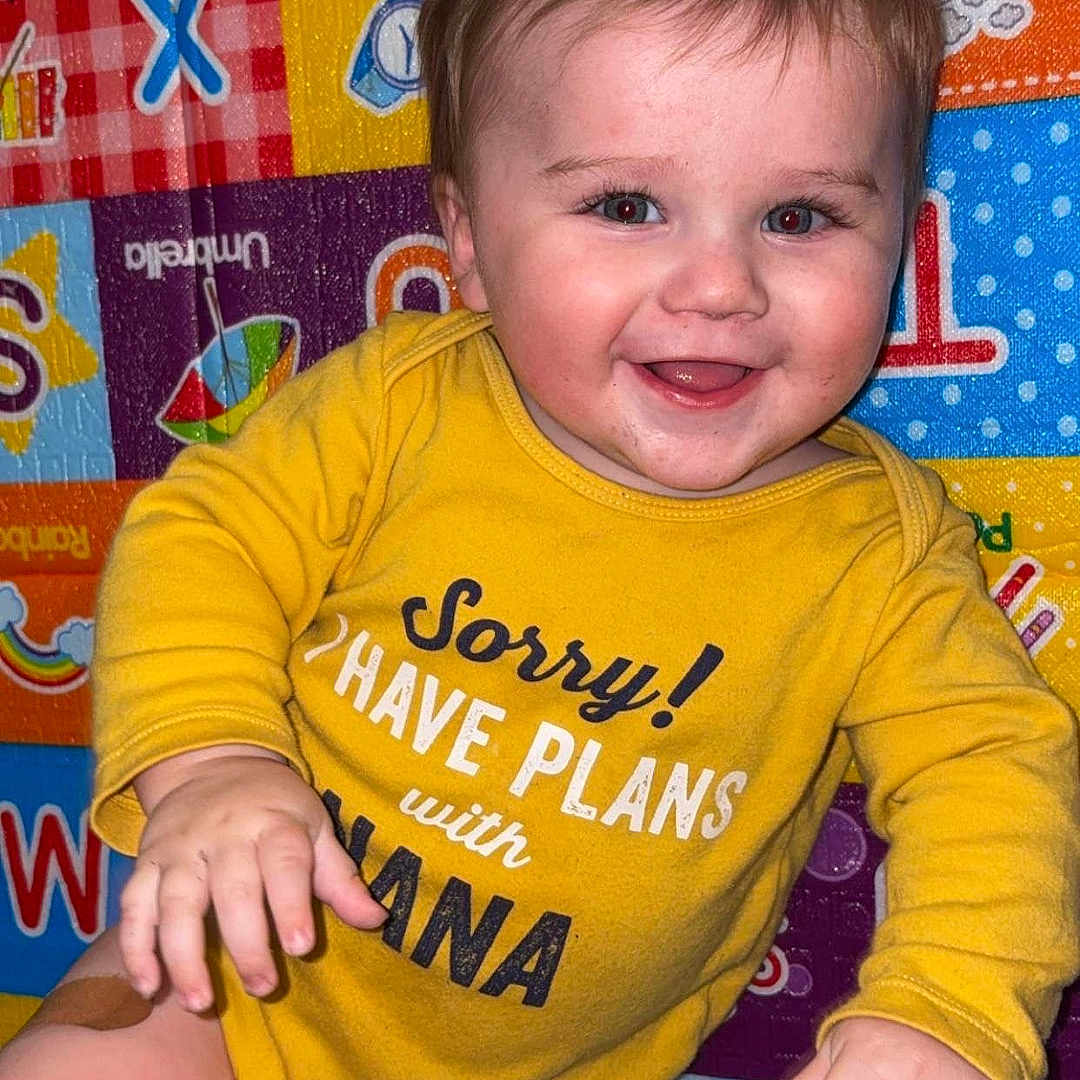 Hayston joined the competition — help win amazing prizes! alphabet, baby, baby_clothing, band_aid, child, colorful, cute, expression, face, hand, happy, indoors, infant, leg, lying_down, person, playmat, skin, smiling, yellow_onesie