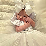 Ellalina is registered to the contest to win money with this photo: baby, white_bow, white_dress, infant, cute, portrait, child, soft_texture, fabric, sitting, adorable, indoor, person, tulle, clothing, newborn, cute_expression, headwear, small_hands, white_background