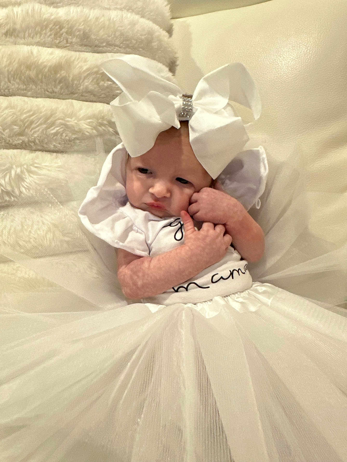 Ellalina is registered to the contest to win money with this photo: baby, white_bow, white_dress, infant, cute, portrait, child, soft_texture, fabric, sitting, adorable, indoor, person, tulle, clothing, newborn, cute_expression, headwear, small_hands, white_background