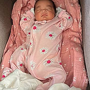 Anaiah joined the competition — help win amazing prizes! baby, sleeping, pink_onesie, blanket, crib, infant, cute, peaceful, child, soft_fabric, floral_pattern, cozy, resting, portrait, indoors, newborn, toddler, pajamas, comfort, relaxation