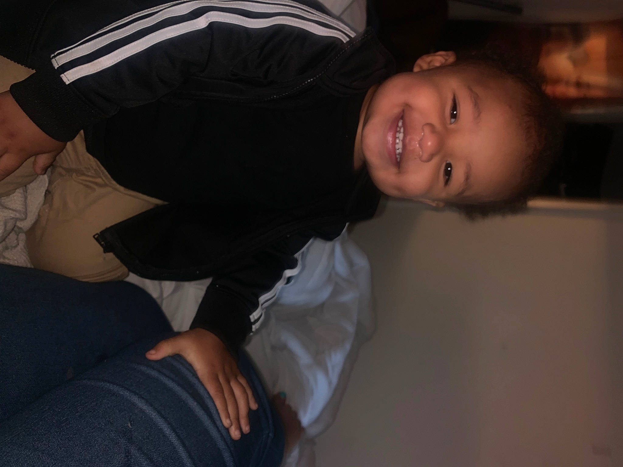 Kendrick is registered to the contest to win money with this photo: cheek, child, clothing, comfort, darkness, elbow, event, flash_photography, formal_wear, fun, gesture, happy, joy, mouth, nose, person, sitting, sleeve, smile, t_shirt