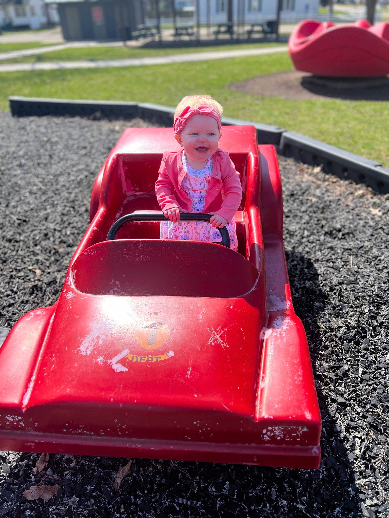 Willow is registered to the contest to win money with this photo: auto_part, automotive_design, automotive_exterior, automotive_wheel_system, bumper, car, classic_car, fun, grass, green, headwear, hood, leisure, magenta, motor_vehicle, person, recreation, red, riding_toy, toddler