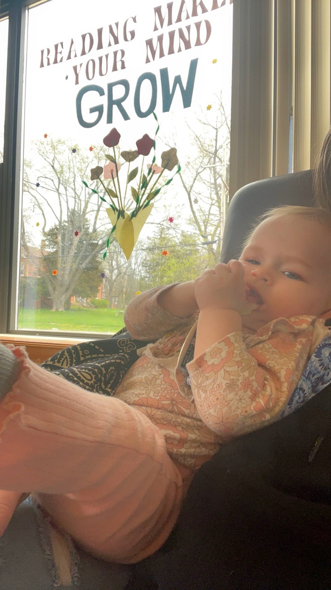 Willow is registered to the contest to win money with this photo: abdomen, baby, chest, comfort, elbow, fun, gesture, grass, hand, happy, human_leg, knee, morning, person, plant, room, sitting, thigh, toddler, tree