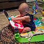 John is registered to the contest to win money with this photo: baby, baby_toys, child, fun, play, sitting, toddler, toy