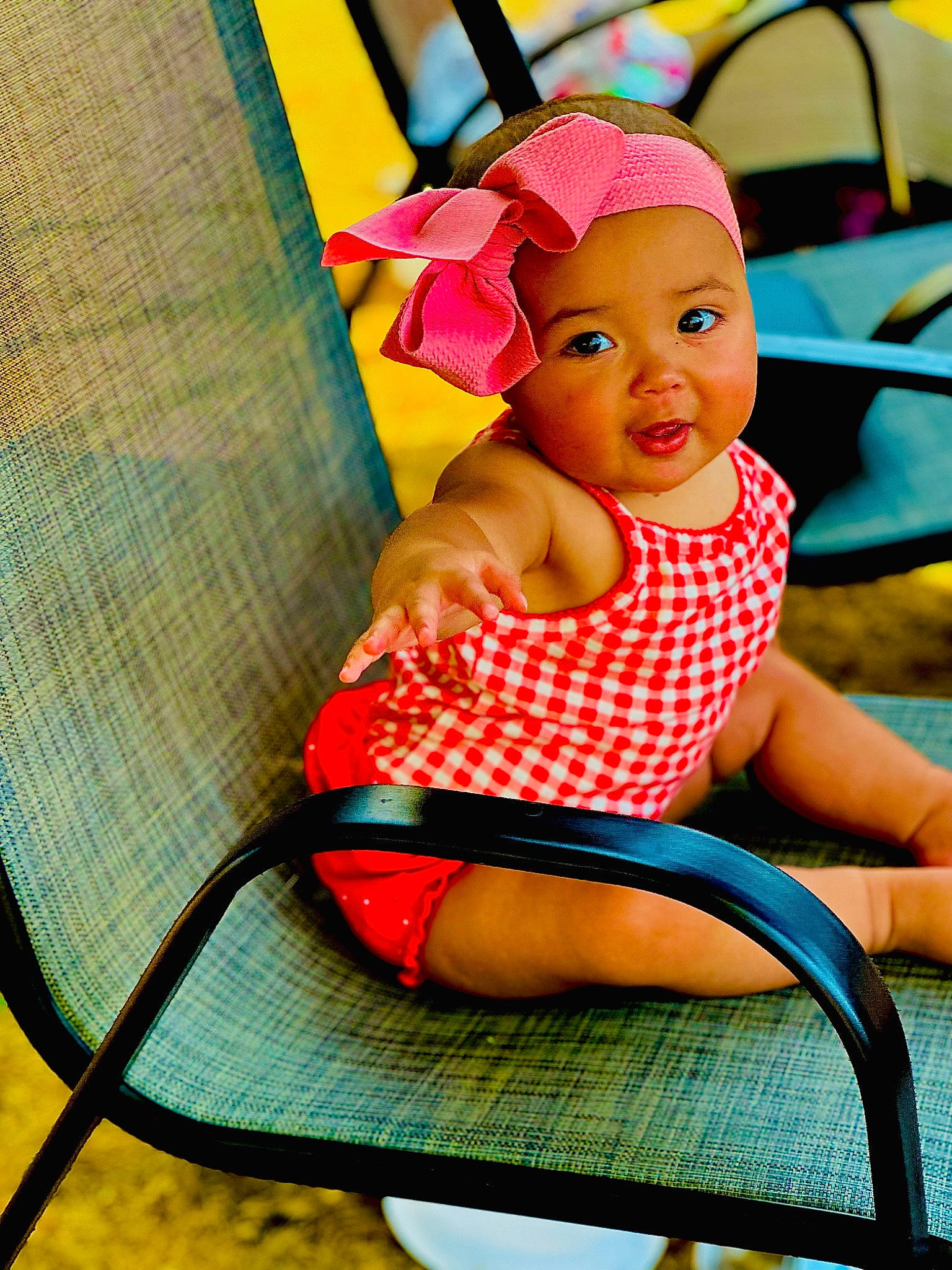 Reighlyn joined the competition — help win amazing prizes! baby_toddler_clothing, chair, child, fashion_accessory, fun, happy, headwear, human_leg, leisure, magenta, pattern, person, pink, play, product, recreation, shorts, sitting, thigh, tints_and_shades