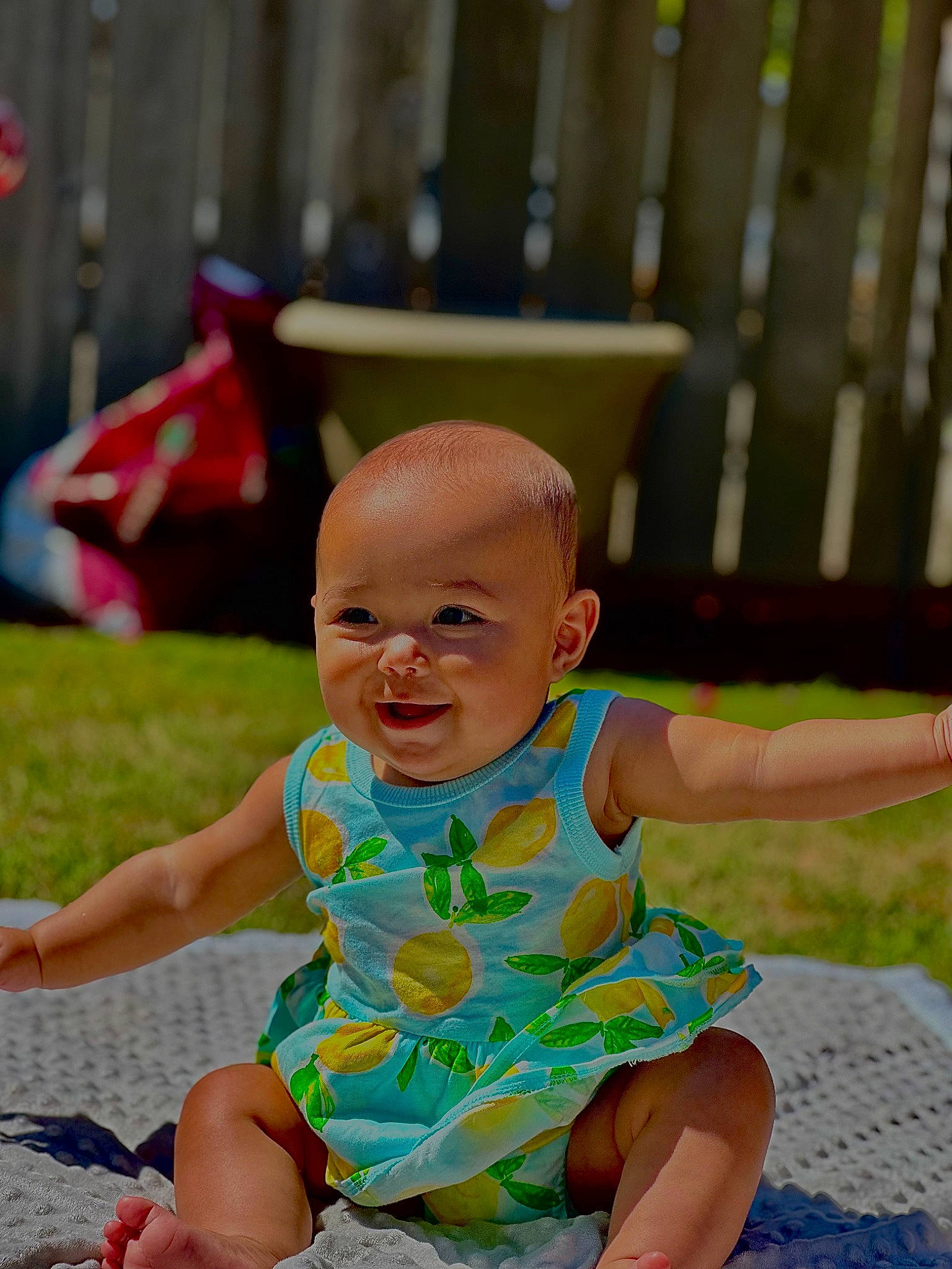 Reighlyn joined the competition — help win amazing prizes! baby, baby_toddler_clothing, barefoot, child, event, foot, fun, grass, happy, leisure, pattern, person, play, recreation, sandal, sitting, skin, smile, t_shirt, toddler