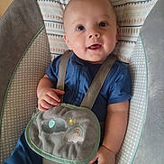 Wyatt is registered to the contest to win money with this photo: baby, child, infant, smiling, blue_clothing, bib, baby_seat, patterned, embroidery, elephant, rainbow, soft_texture, indoor, happy, face, hands, cute, portrait, seated, young