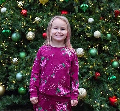 Mckenna joined the competition — help win amazing prizes! christmas, christmas_decoration, christmas_ornament, christmas_tree, decor, fir, girl, holiday, joy, pattern, person, rose_family, smile, toddler, tree