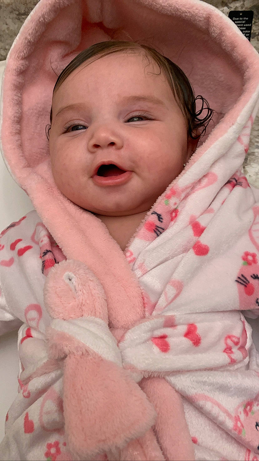 Ariyah joined the competition — help win amazing prizes! baby, baby_products, baby_toddler_clothing, cheek, child, comfort, face, facial_expression, happy, headwear, linens, lip, nose, person, pink, product, skin, sleeve, smile, textile