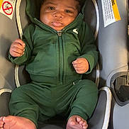 Nas joined the competition — help win amazing prizes! baby, infant, green_hoodie, car_seat, tongue_out, cute, child, smiling, clothing, seat_belt, indoor, infant_clothing, foot, hand, head, face, person, warning_label, fabric, soft