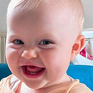 Aria is registered to the contest to win money with this photo: baby, smiling, face, child, indoor, person, happy, portrait, cute, infant, head, clothing, skin, mouth, eyes, cheeks, joy, expression, young, sitting