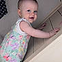 Aria joined the competition — help win amazing prizes! baby, child, smiling, stairs, climbing, indoor, person, face, hands, colorful_clothing, butterfly_pattern, floral_pattern, white_sleeveless_shirt, cute, young_child, blue_eyes, short_hair, skin, wooden_stairs, playful