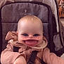 baby, stroller, child, face_filter, heart_shapes, pink_jacket, seatbelt, indoor, cute, smile, hand, blond_hair, infant, playful, cartoon_effect, expression, seated, clothing, babyhood, adorable