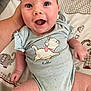 baby, smiling, onesie, cat_illustration, hand, blanket, elephant_pattern, hearts, infant, cute, happy, child, clothing, lying_down, indoor, person, young_child, skin, face, expression