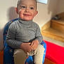 child, toddler, portrait, smiling, indoor, turtleneck, sweater, chair, seat, hands, face, eyes, cheeks, staircase, bokeh, sunlight, socks, cozy, happy, baby furniture