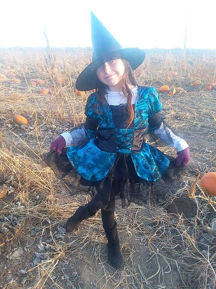 Alison joined the competition — help win amazing prizes! agriculture, costume, doll, fashion_accessory, fawn, grass, mountain, outerwear, person, plant, sitting, tree