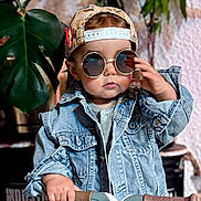Augustin participe au concours pour gagner de l'argent avec cette photo : accessory, cap, casual, child, confident, cool, cute, denim_jacket, face, fashion, hand, indoor, leaf, person, plant, portrait, scooter, sunglasses, toddler, young_child