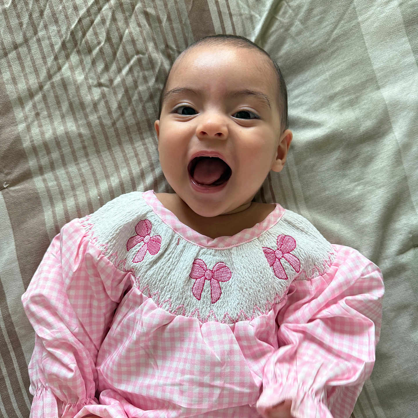 Maysen Ray is registered to the contest to win money with this photo: baby, babylaughing, blouse, bodypart, clothing, dress, face, furniture, happy, head, laughing, mouth, newborn, person, photography, portrait, quilt, sitting, smile, teeth