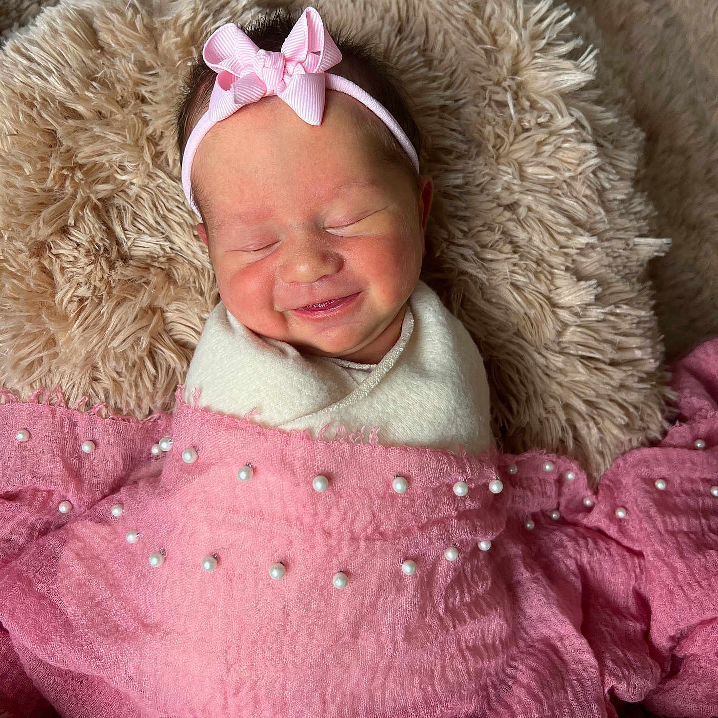 Stevie James is registered to the contest to win money with this photo: baby, blanket, child, closeup, cozy, cushion, cute, happy, headband, indoors, infant, newborn, pearl_decor, pink_bow, portrait, resting, sleeping, smiling, soft_texture, swaddled
