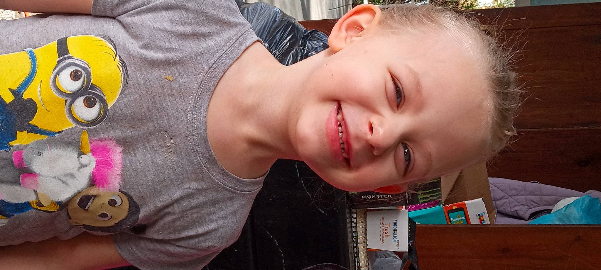 Luna is registered to the contest to win money with this photo: baby, black_hair, cheek, chest, child, ear, eyelash, fun, grass, happy, joy, lip, mouth, neck, nose, pattern, person, smile, t_shirt, tire