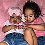 baby, toddler, child, pink_bow, denim_shorts, pink_shirt, blanket, cute, sleepy, cuddling, indoor, portrait, two_children, infant, soft_texture, casual_clothing, close_up, skin, hands, face