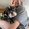 Ayani Rose joined the competition — help win amazing prizes! man, puppy, dog, indoor, portrait, smile, hug, pet, cute, wrinkles, young_adult, casual_clothing, brown_dog, short_hair, happy, holding, closeup, domestic_life, animal, friendship
