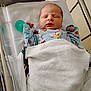 Chase is registered to the contest to win money with this photo: newborn, baby, sleeping, hospital, bassinet, blanket, onesie, clothing, infant, cute, peaceful, child, person, bed, healthcare, nursery, resting, soft, indoor, small