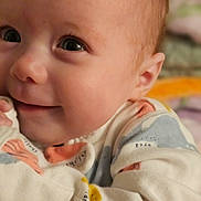 Avacyn joined the competition — help win amazing prizes! baby, cheeks, child, close_up, cozy, cute, eyes, face, happy, indoor, infant, newborn, onesie, patterned_clothing, portrait, skin, small_hands, smile, soft_lighting, warmth