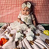 baby, bow, bunny, child, cute, dress, easter_eggs, furniture, girl, pink, plush, portrait, sitting, sock, soft_toy, striped_blanket, teddy_bear, toddler, toy, white